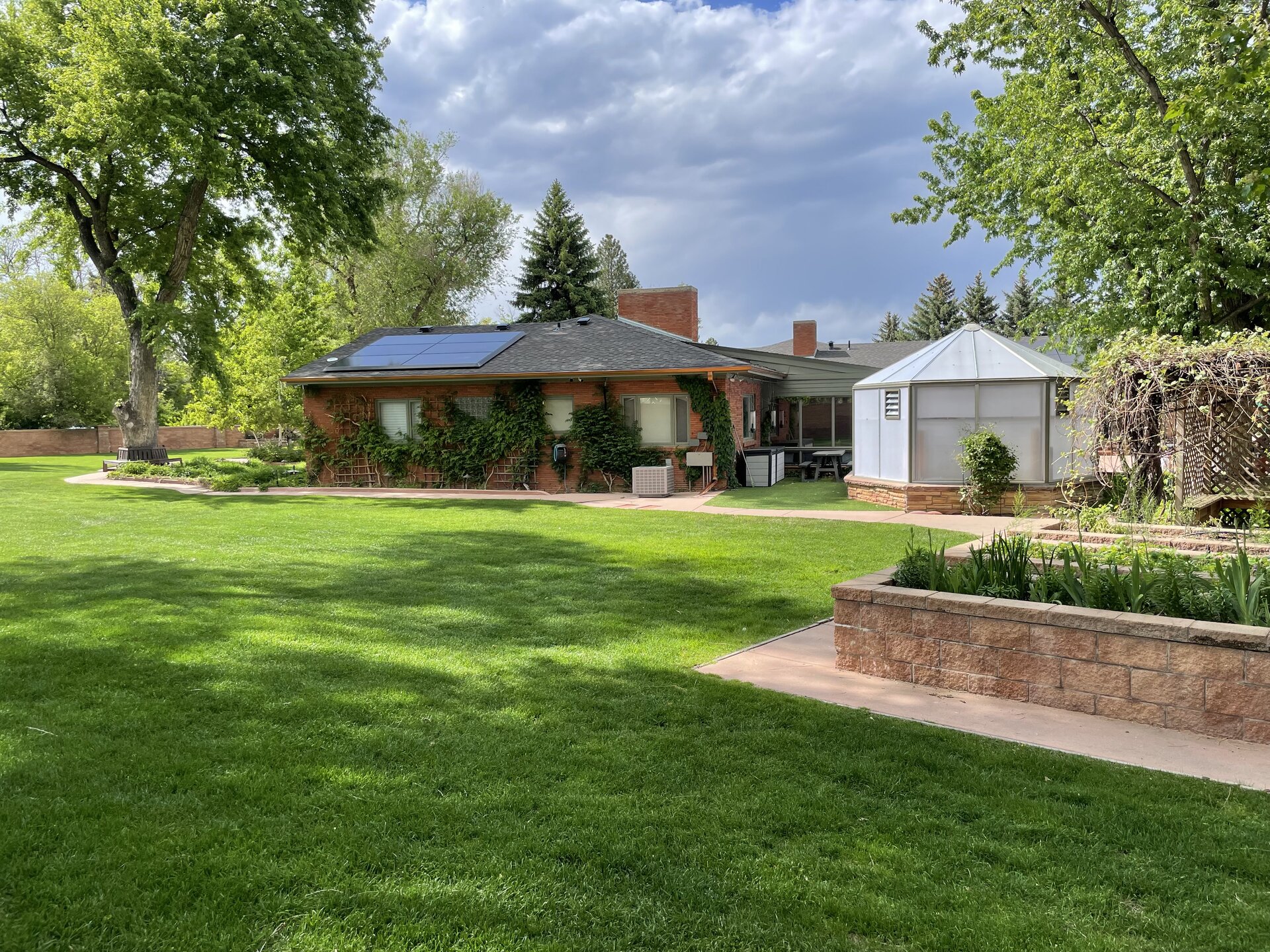 The greenhouse, house, and rooftop solar system in Longmont